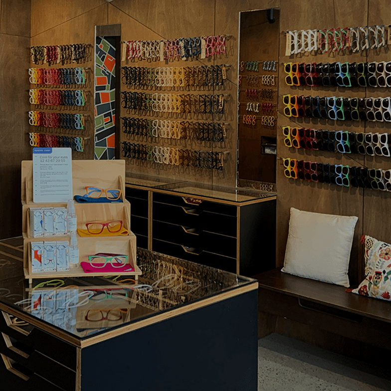 Interior of Dresden Vision Rozelle optical store featuring colorful eyewear displays and sustainable wood decor.